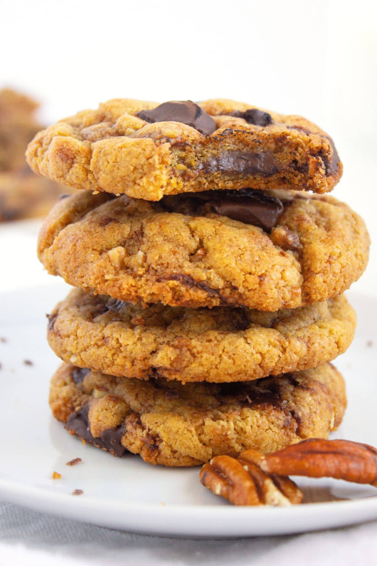 A stack of half-eaten gluten-free tahini chocolate chip cookies.