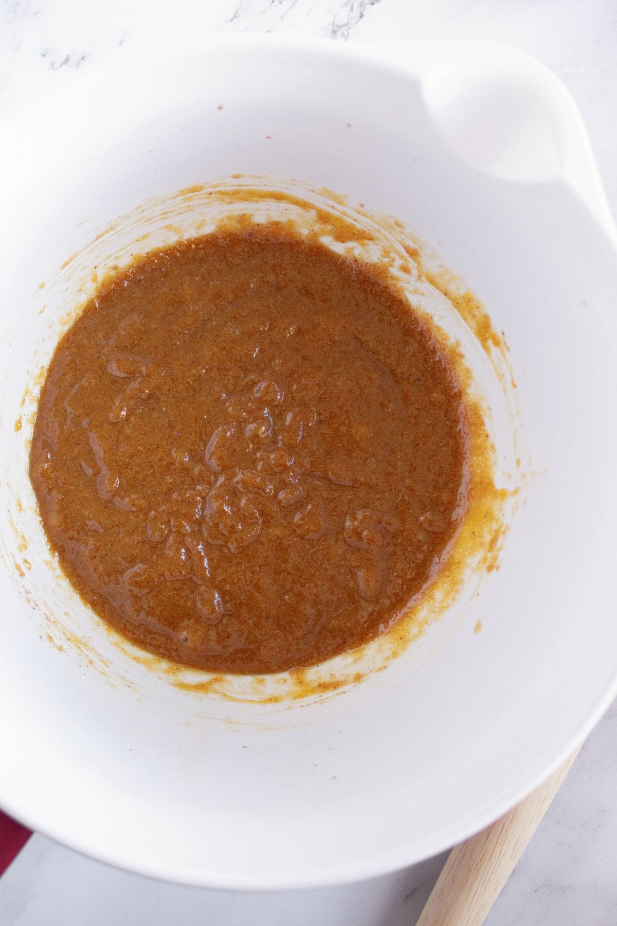 A brown viscious mixture in white bowl