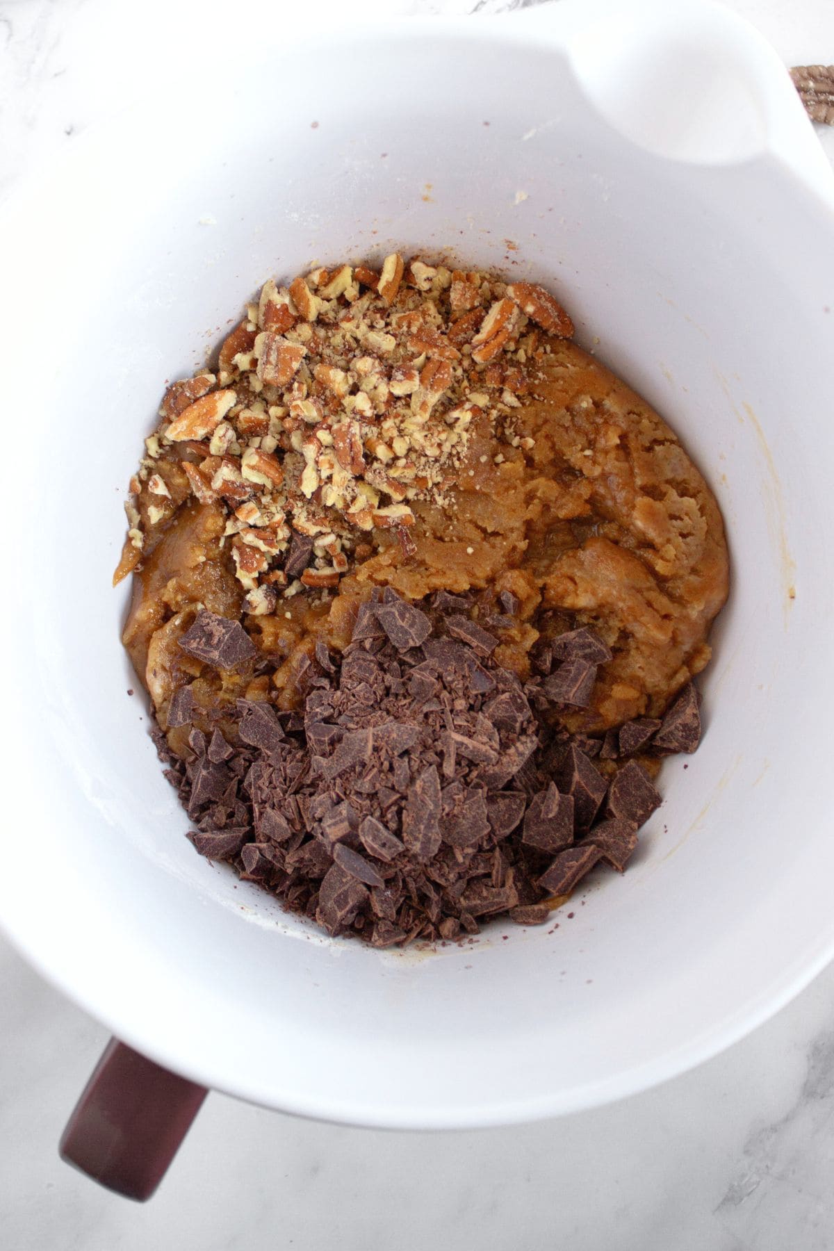 Chocolate chip cookie dough in mixing bowl.