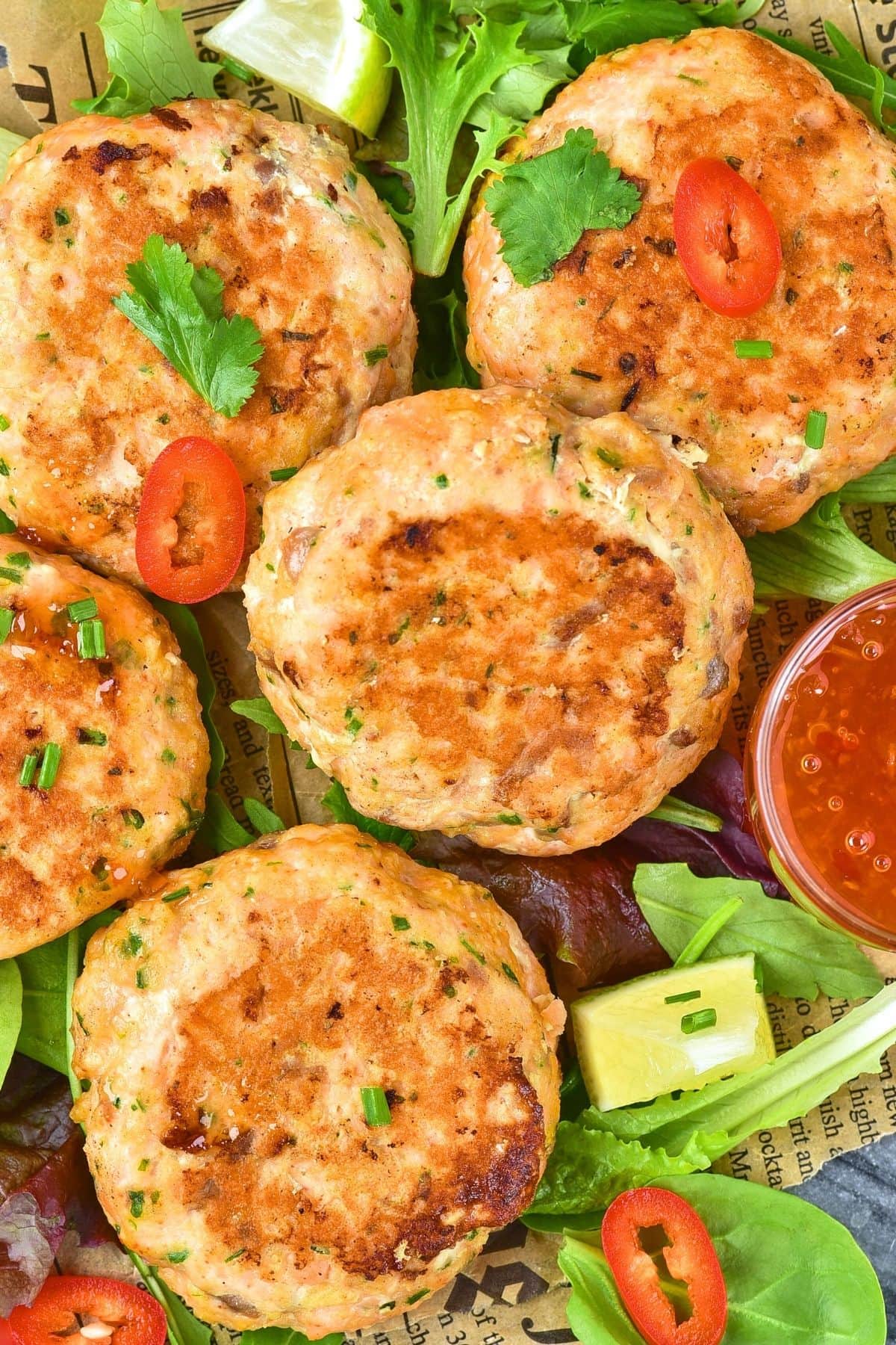 Up close view of Thai salmon cakes on parchment paper.