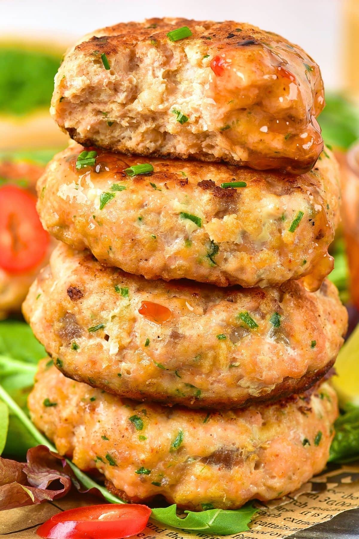 A stack of half-eaten salmon Thai fish cakes.