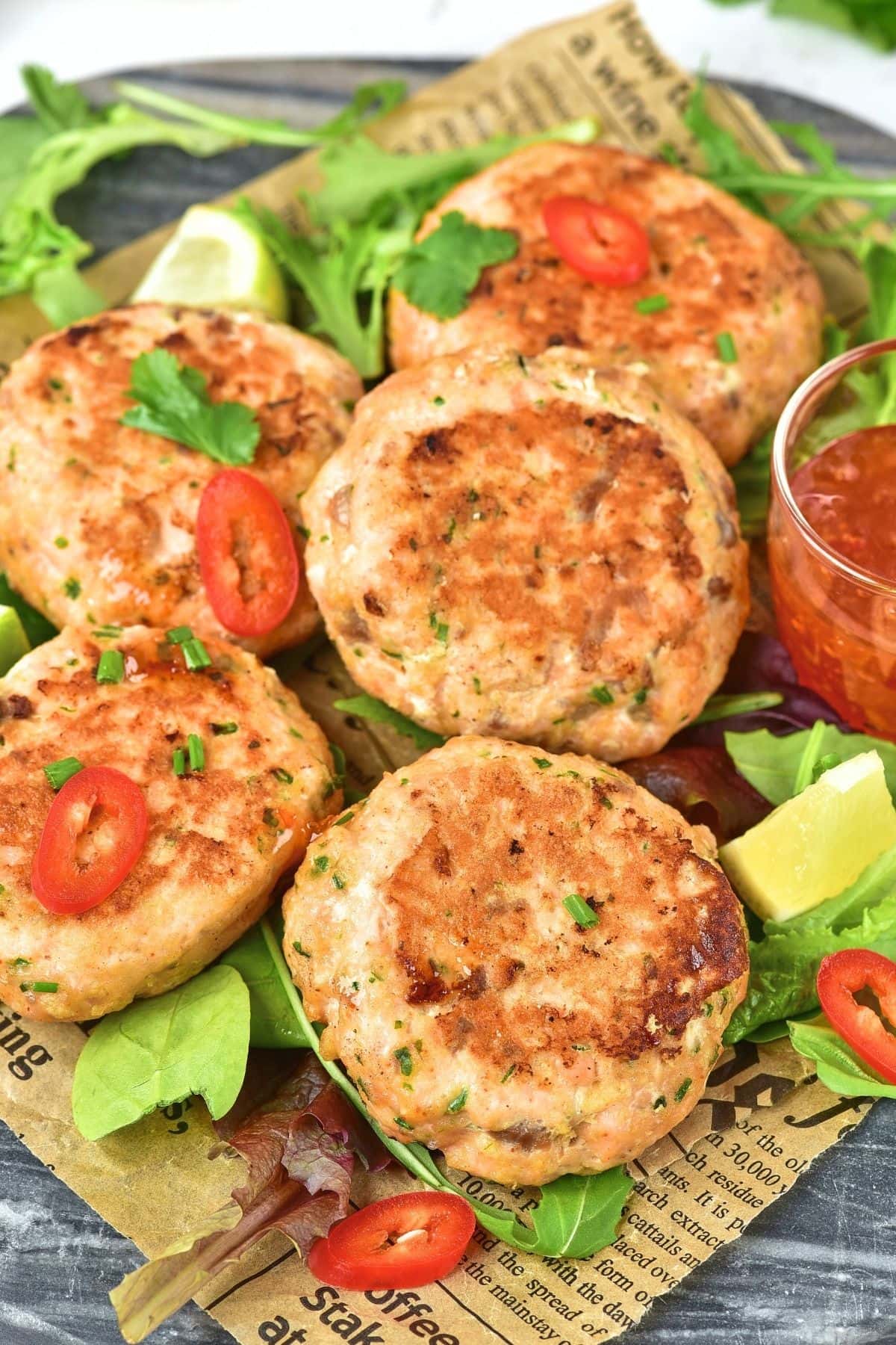 Up close view of salmon fish cakes on parchment paper.