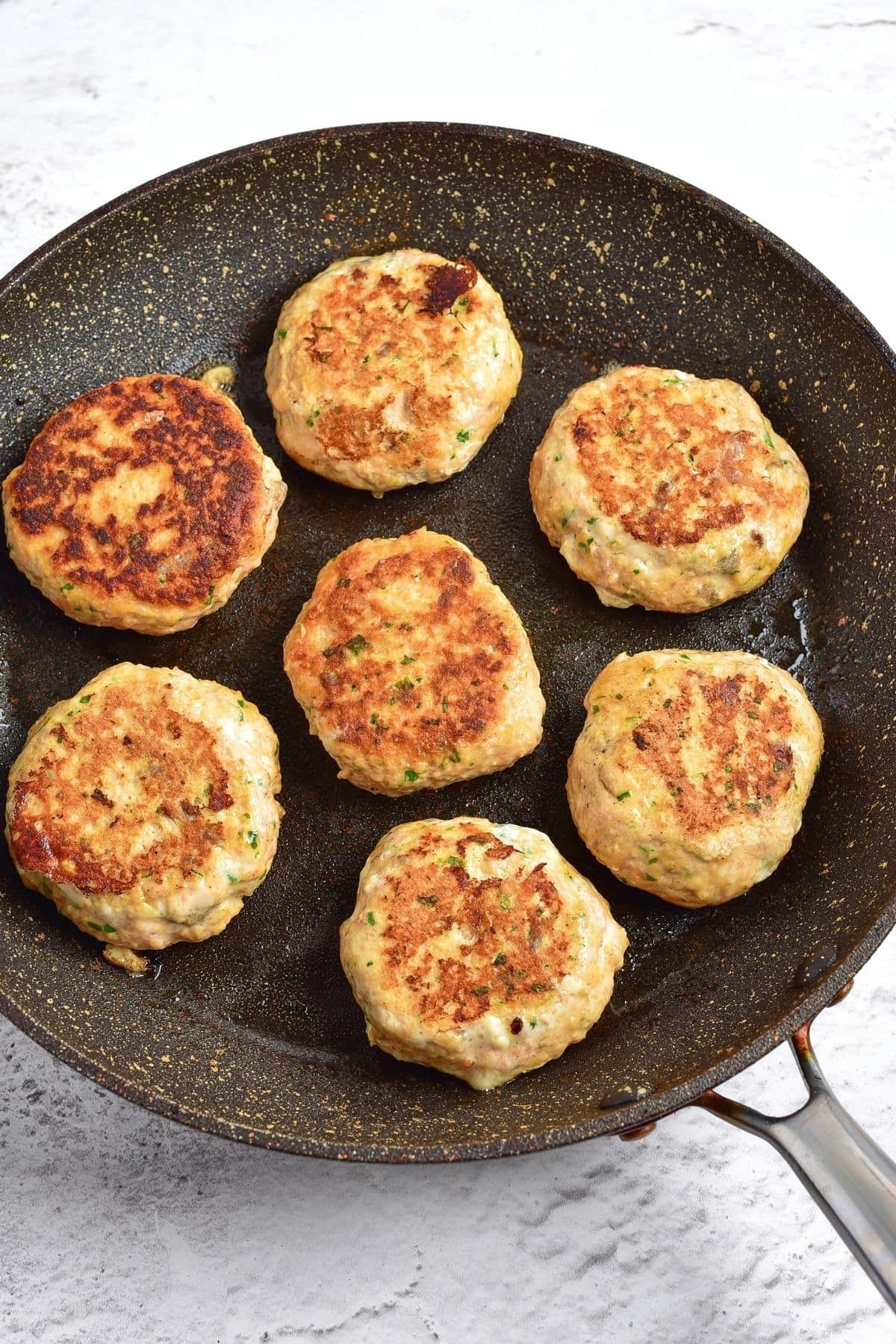Cooked salmon cakes in skillet