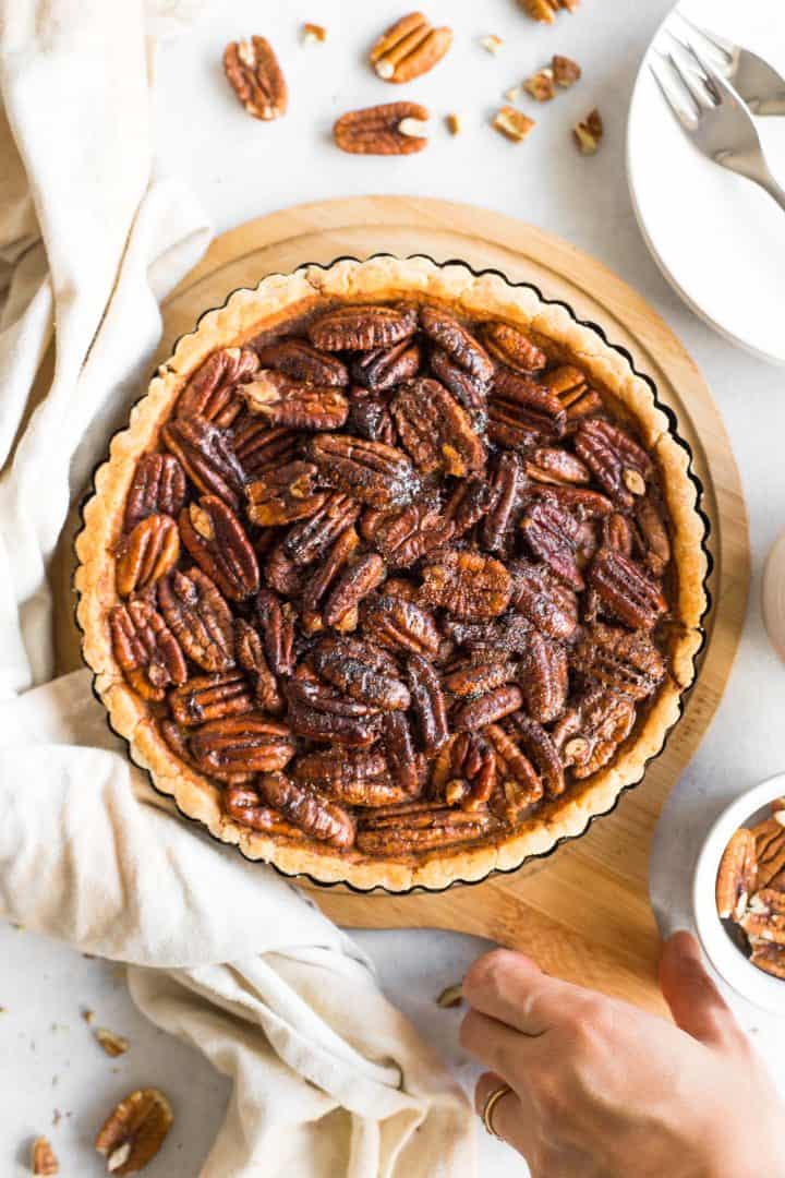 Top down view of pecan pie on wooden board.