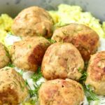 Meatballs over a bowl of rice
