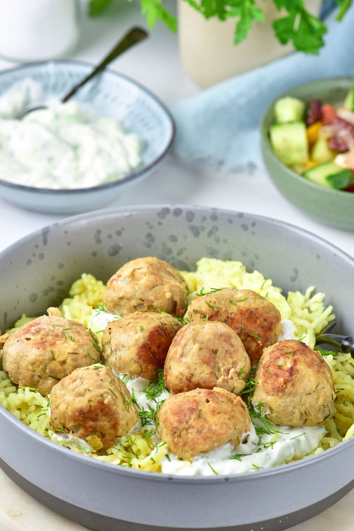 A bowl of turkey and feta meatballs with rice.