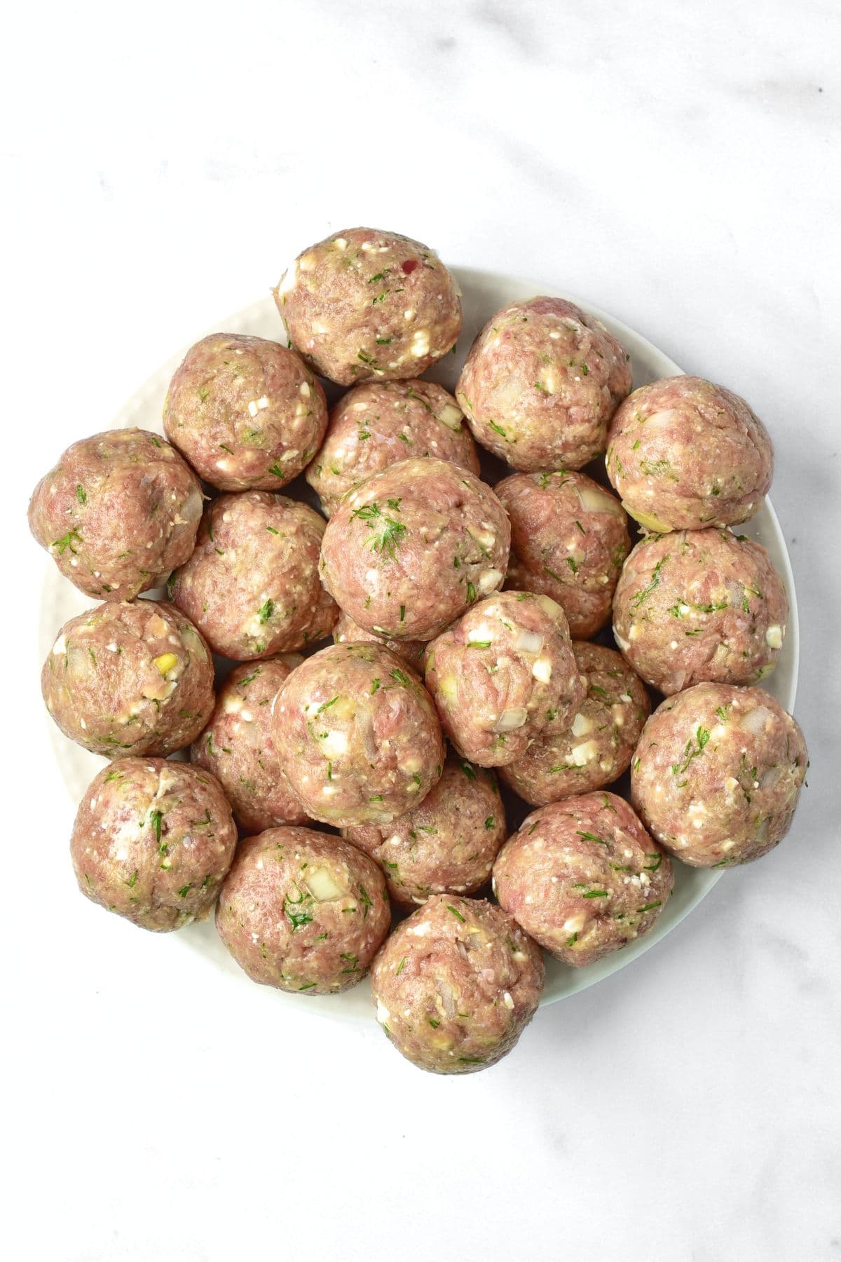 Uncooked meatballs on a plate