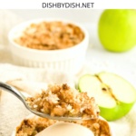 Holding up a spoonful of apple crumble.