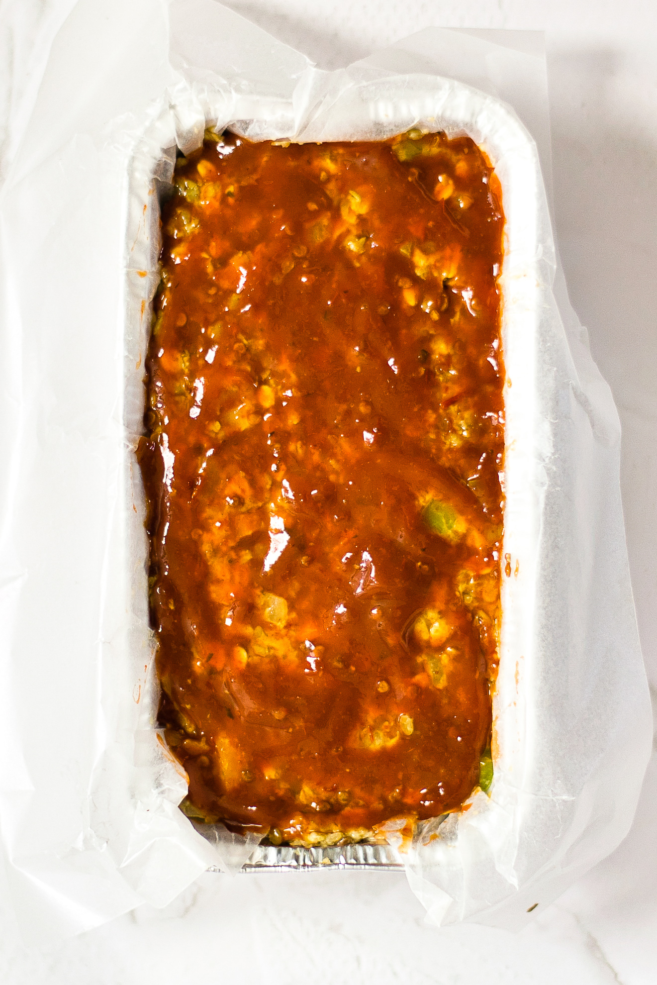 Vegan meatloaf slathered with tomato sauce.