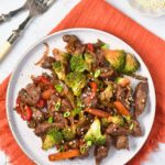 A plate of stir fried venison with veggies