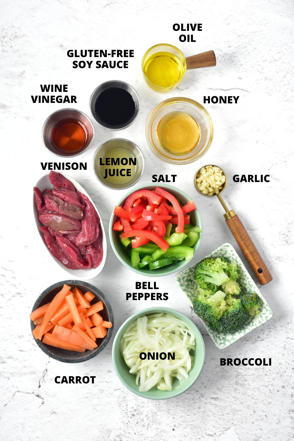 Ingredients for venison stir fry recipe laid out on marble board.