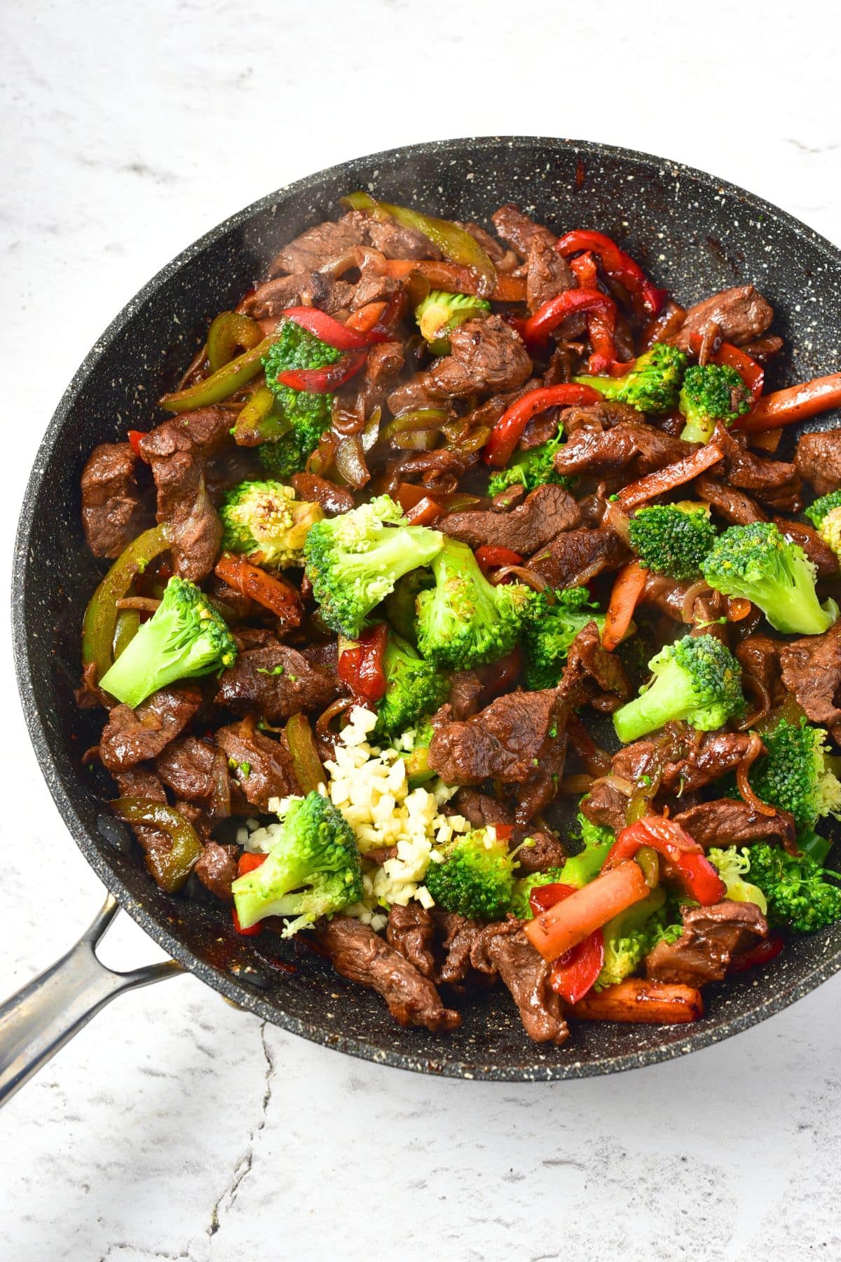 A skillet of venison stir fry with broccoli.