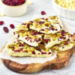 A stack of white chocolate bark with cranberries and pistachios