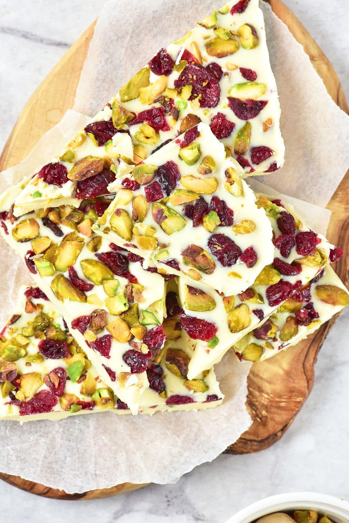 Top down view of white chocolate bark with cranberries and pistachios