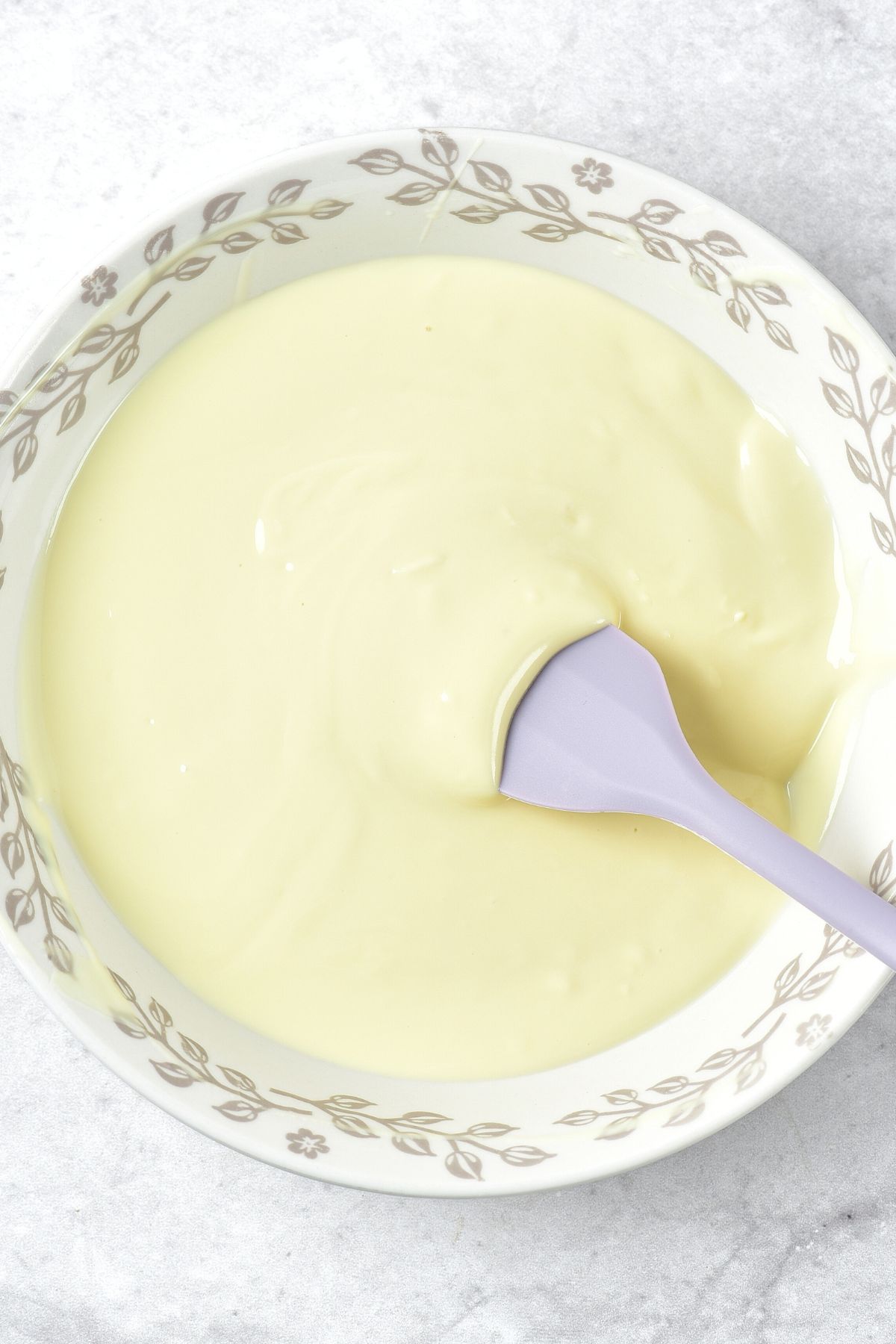 Stirring melted white chocolate mixture with spatula