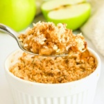 Holding up a spoonful of apple crumble.