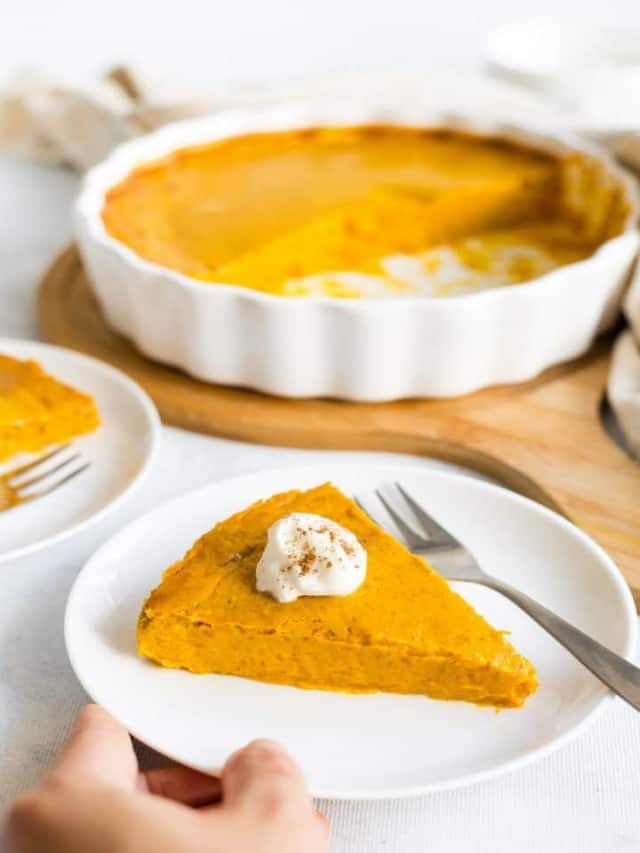 resized image of slice of pumpkin pie on white plate with dollop of whipped cream on top , pie in white ceramic pie dish on wood board